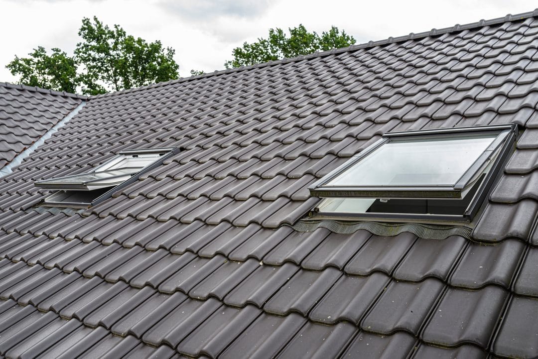 two open roof windows in the attic visible anthracite ceramic tiles
